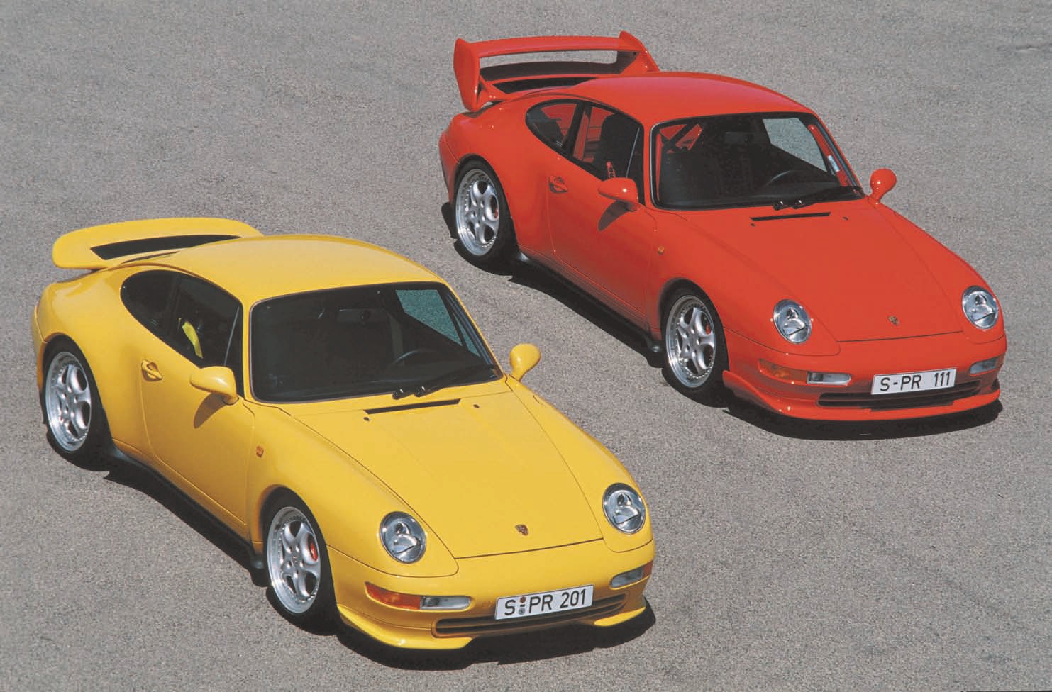To homologate the 993 Carrera RSR 3.8 for racing, Zuffenhausen produced a run of 1,014 street-legal 300-horsepower RS 3.8 models in 1995, including this yellow coupe. On the right is the M003 RS 3.8 Club Sport, of which Porsche assembled 227. Porsche Archiv