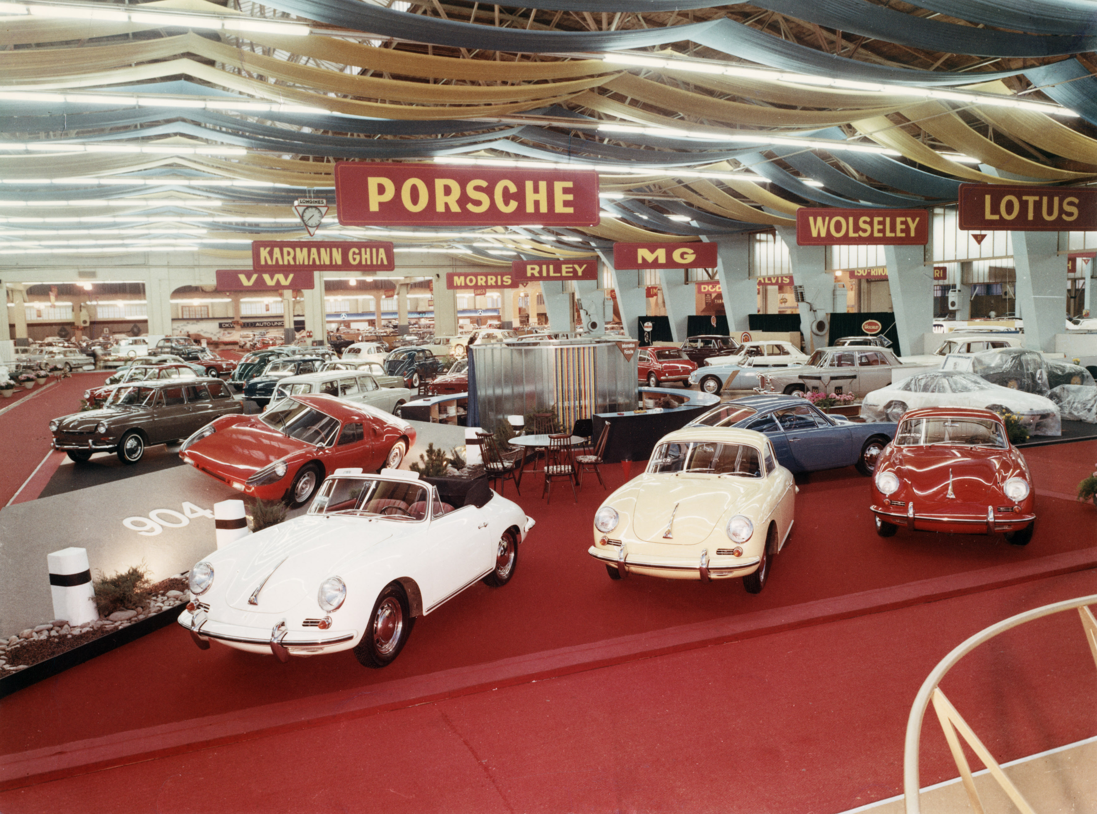 Six months after the Frankfurt debut, Porsche showed a Quick Blue–painted 911 prototype, chassis 13 326, along with a bright red 904 at the Geneva, Switzerland, auto show. Porsche shared show space with Volkswagen. Porsche Archiv